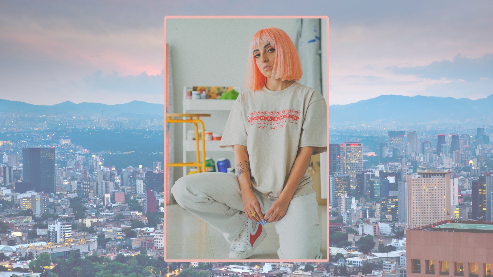 A person with pink hair on a background of a city
