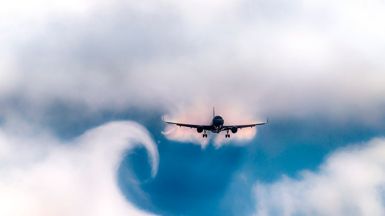 Cloud curve from wake turbulence after plane pass by